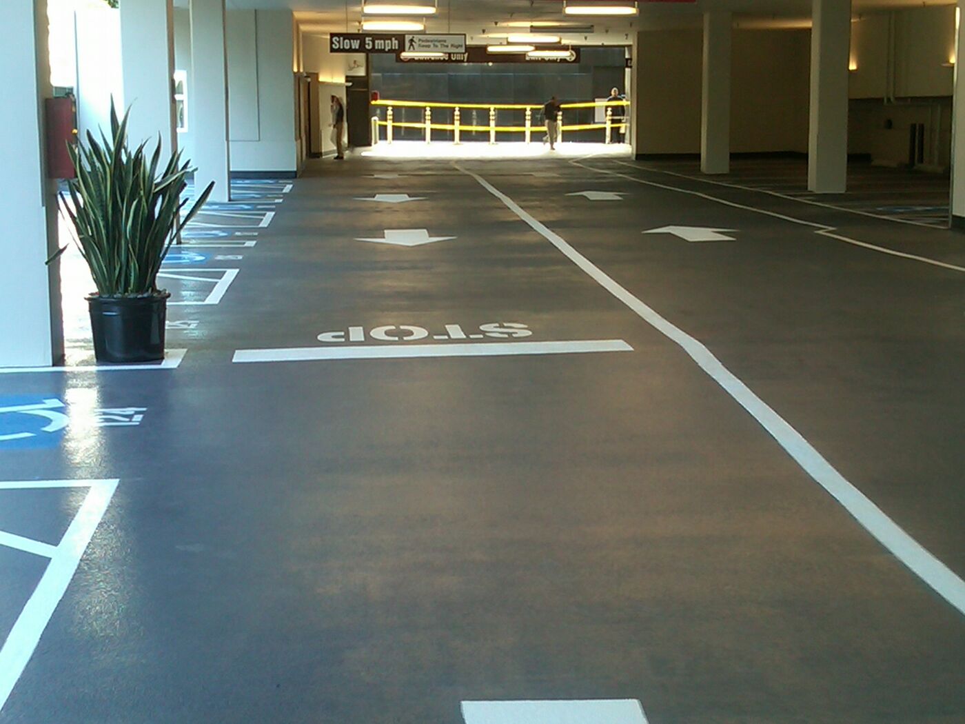 Coated parking deck with new striping in a CBRE-managed garage